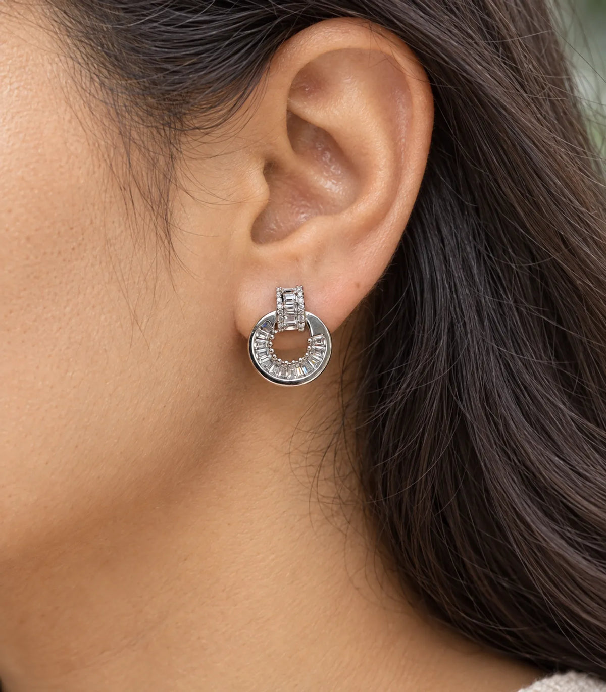 Close view of Silver Baguette Halo Circle Earrings and asymmetric baguette arc