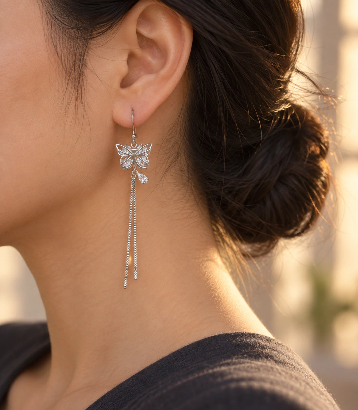 JIMIKI Silver Butterfly Crystal Chain Drop Earrings in Silver Tone, editorial model view