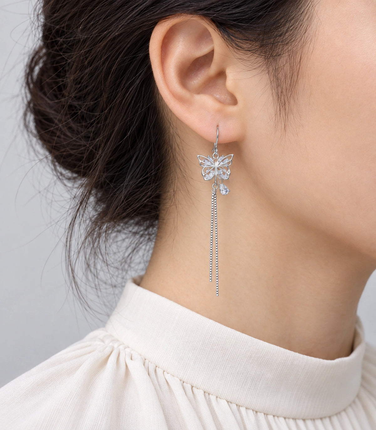 JIMIKI Silver Butterfly Crystal Chain Drop Earrings in Silver Tone, model wearing view