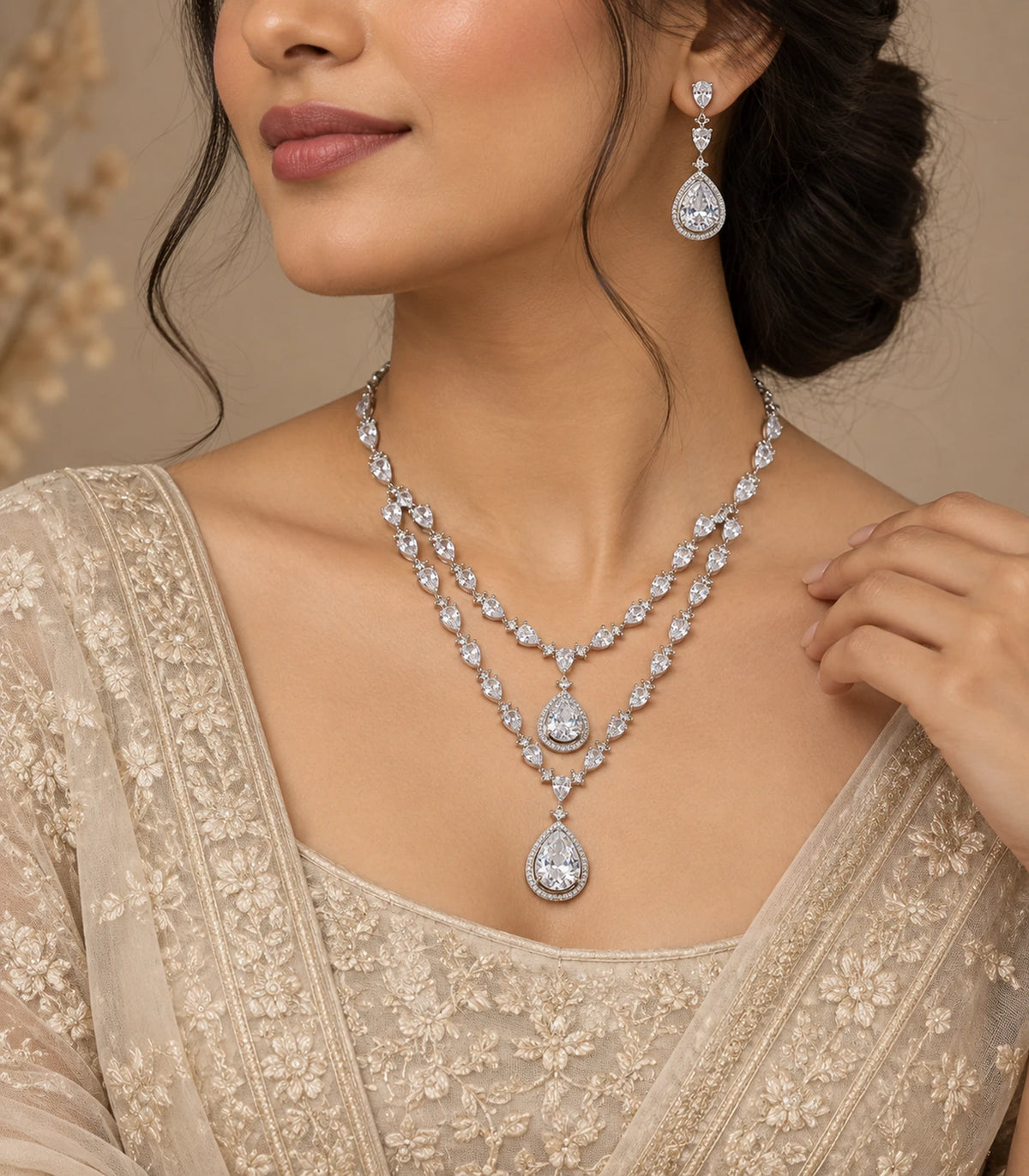Silver clear layered necklace set worn with a beige embroidered outfit