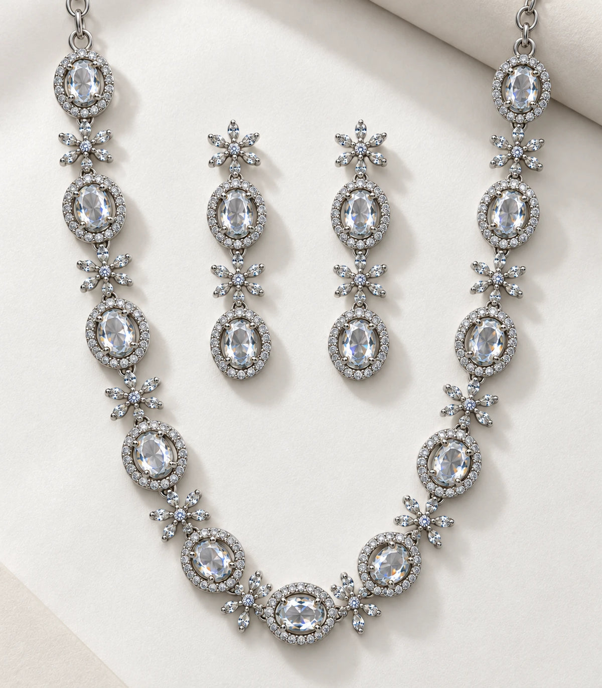 Detail view of the silver clear oval floral necklace set and earrings