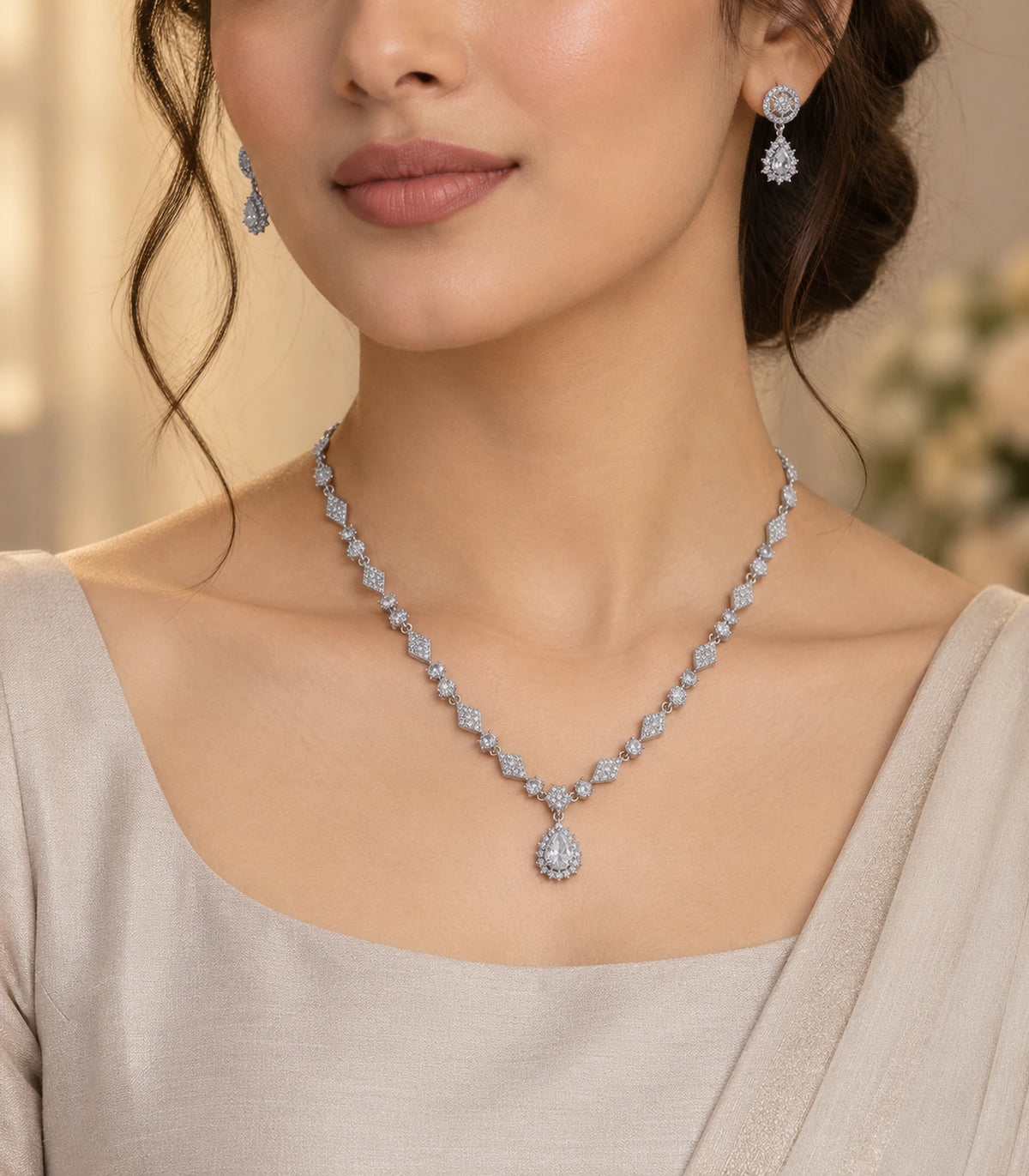 Silver-tone clear necklace and matching earrings in an editorial worn view