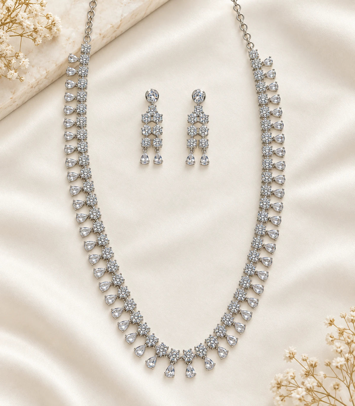 Silver Clear Teardrop Crystal Necklace Set with matching pair of earrings on fabric