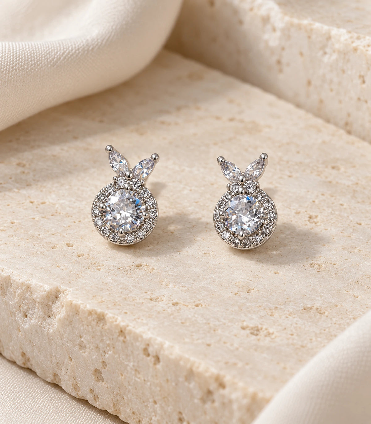 JIMIKI Crystal Halo Leaf Stud Earrings in Silver - editorial-flatlay #color_silver