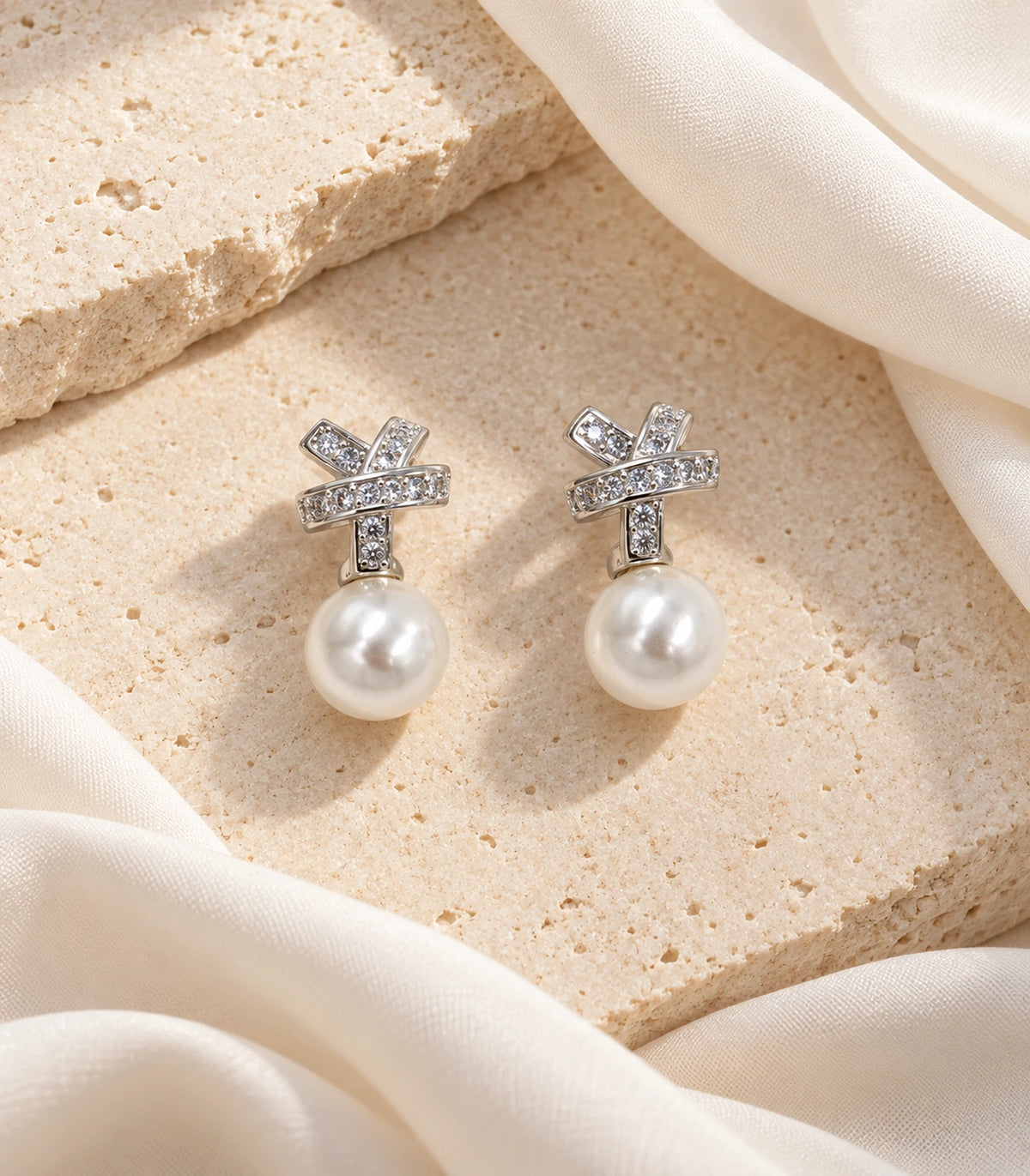 JIMIKI Silver Crystal Knot Pearl Drop Earrings - editorial-flatlay #color_silver