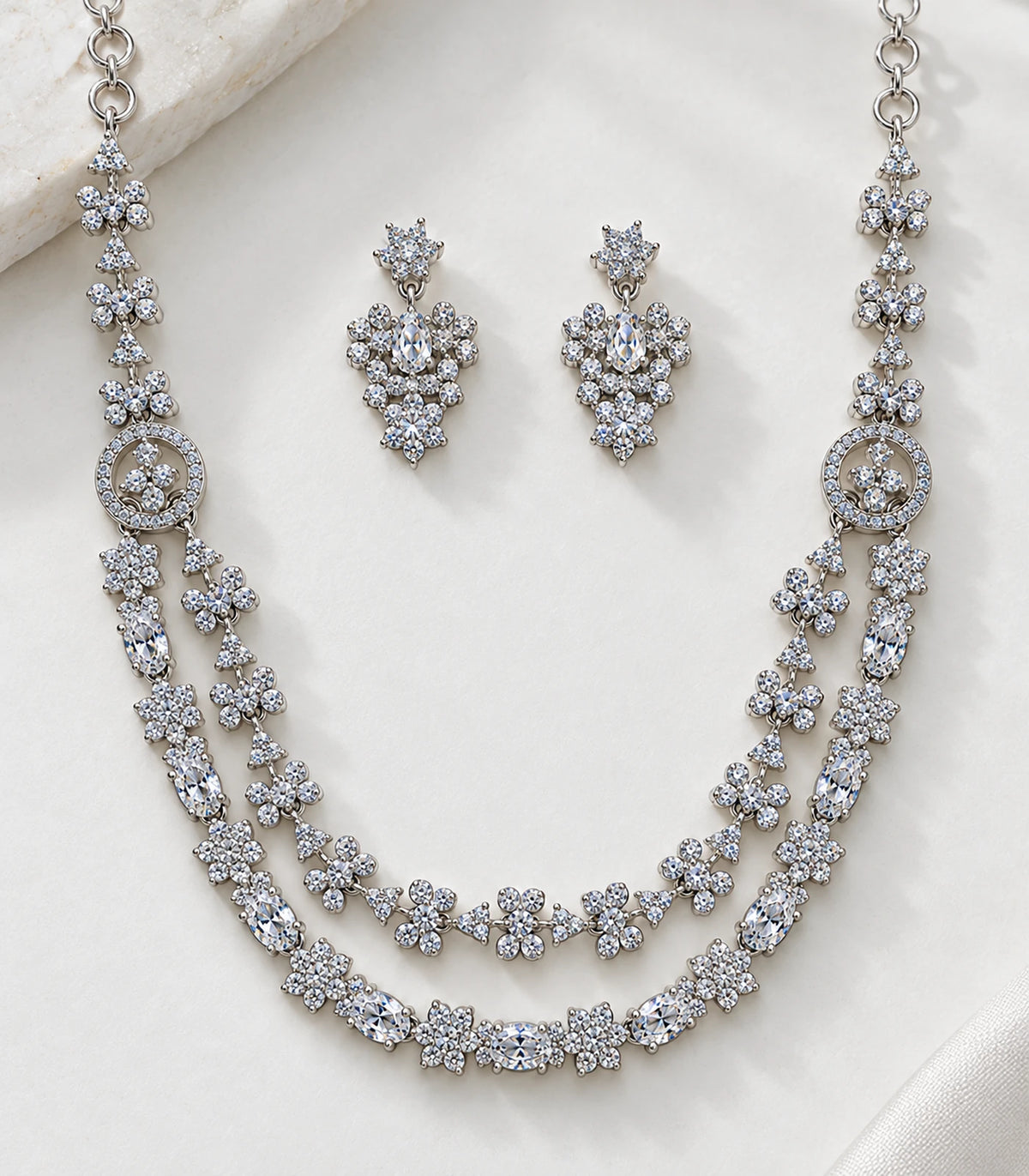 Detail of clear stones, floral links and circular connectors in the necklace set with matching earrings