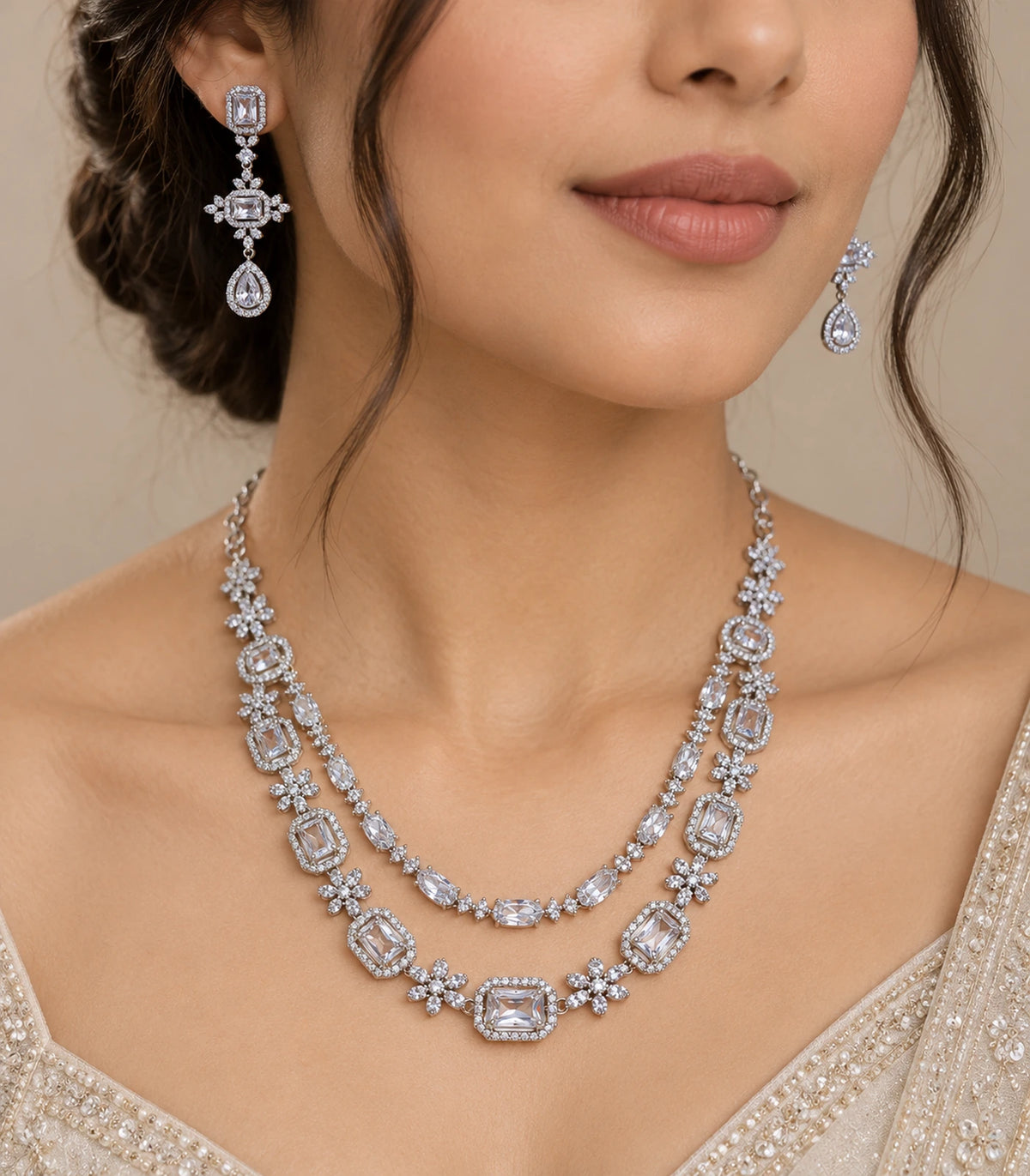 Close view of the silver-tone clear-stone necklace set worn at the neckline