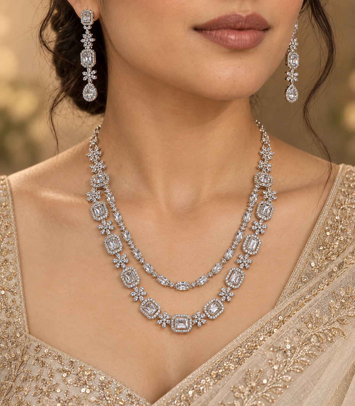 Silver-tone double-layer necklace set styled with a gold-toned saree