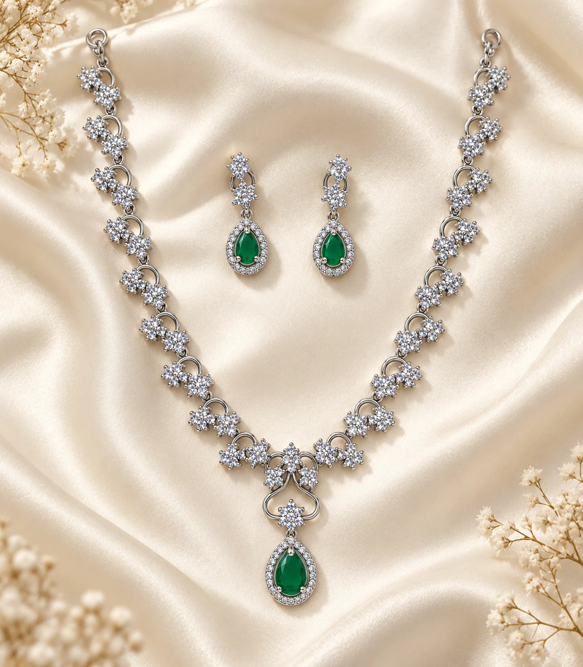 Silver Emerald Teardrop Crystal Necklace Set arranged on cream fabric