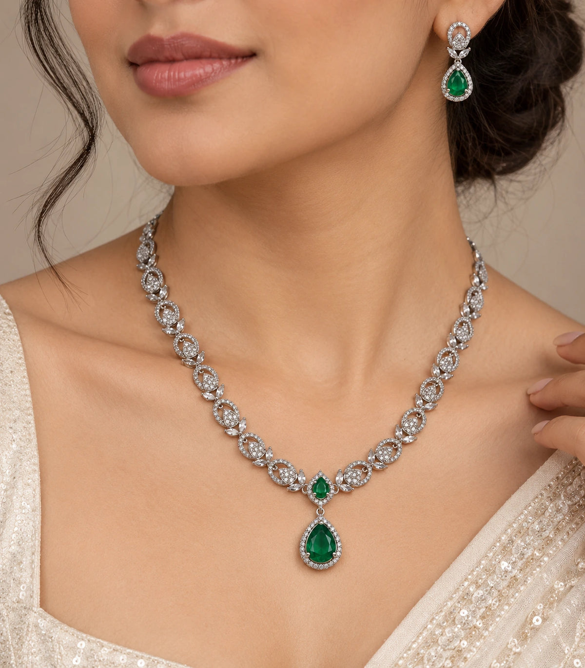 Close view of the green teardrop necklace and matching earring worn naturally