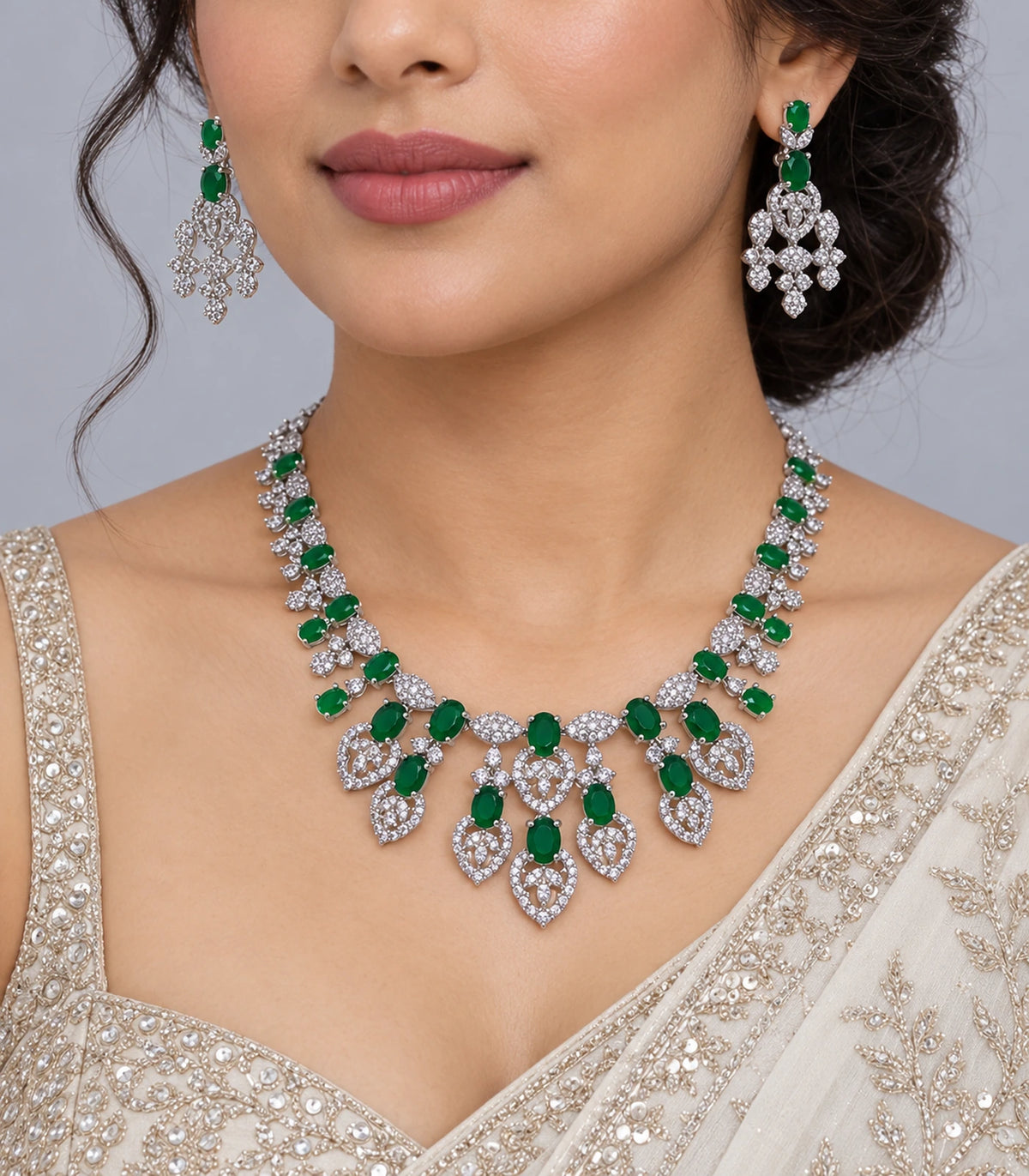 Emerald-green and silver-tone necklace set worn with a cream outfit