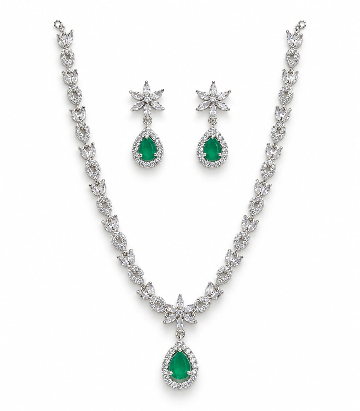 Silver-tone necklace and matching floral earrings with emerald-green teardrop accents on white