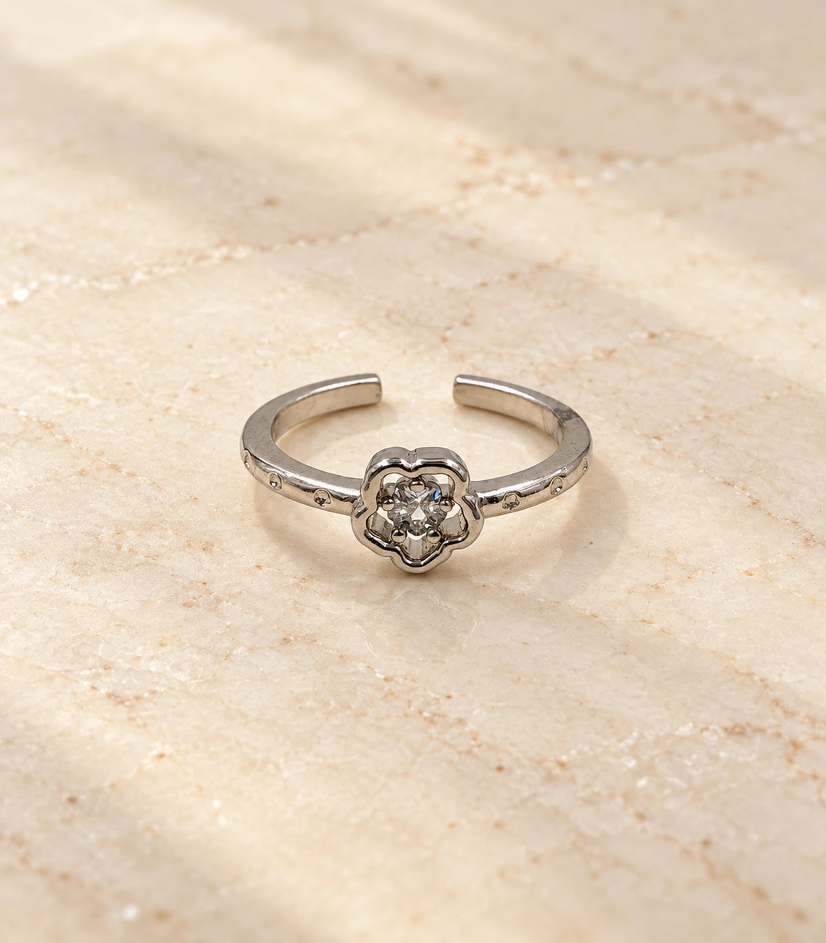 Silver flower crystal open ring — editorial flatlay