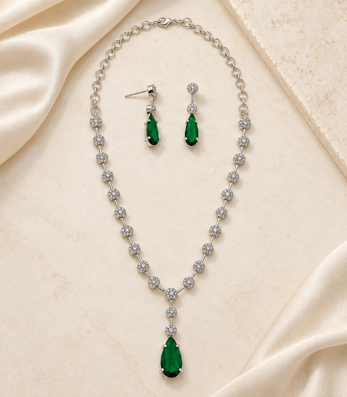 Silver Green Teardrop Necklace Set with necklace and two earrings on a styled flat lay