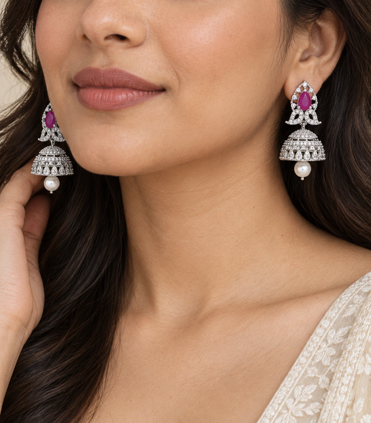 Matching silver-tone magenta butterfly pearl-style jhumka earrings shown worn in close view