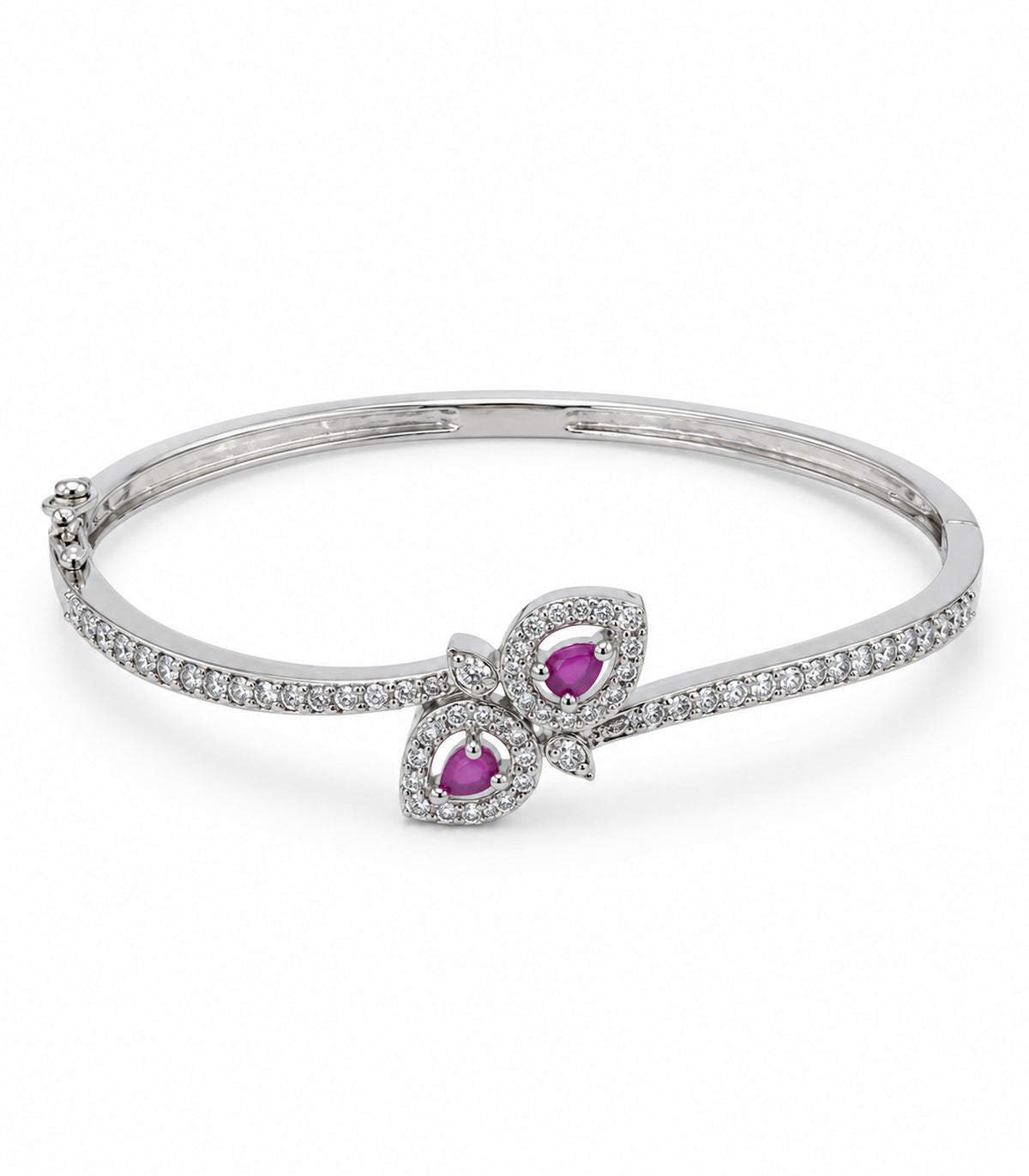 Silver-tone hinged bangle with two magenta teardrops in open leaf halos and two small clear leaves on white