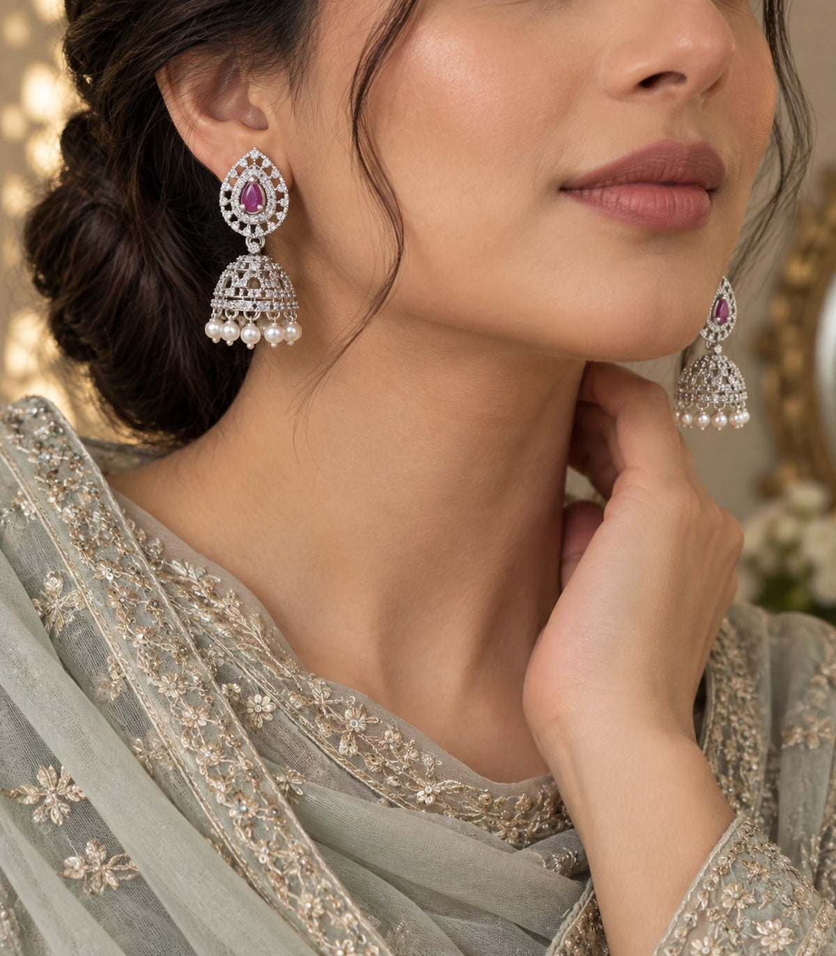 Styled worn view of the silver-tone magenta openwork pearl-fringe jhumka earring pair