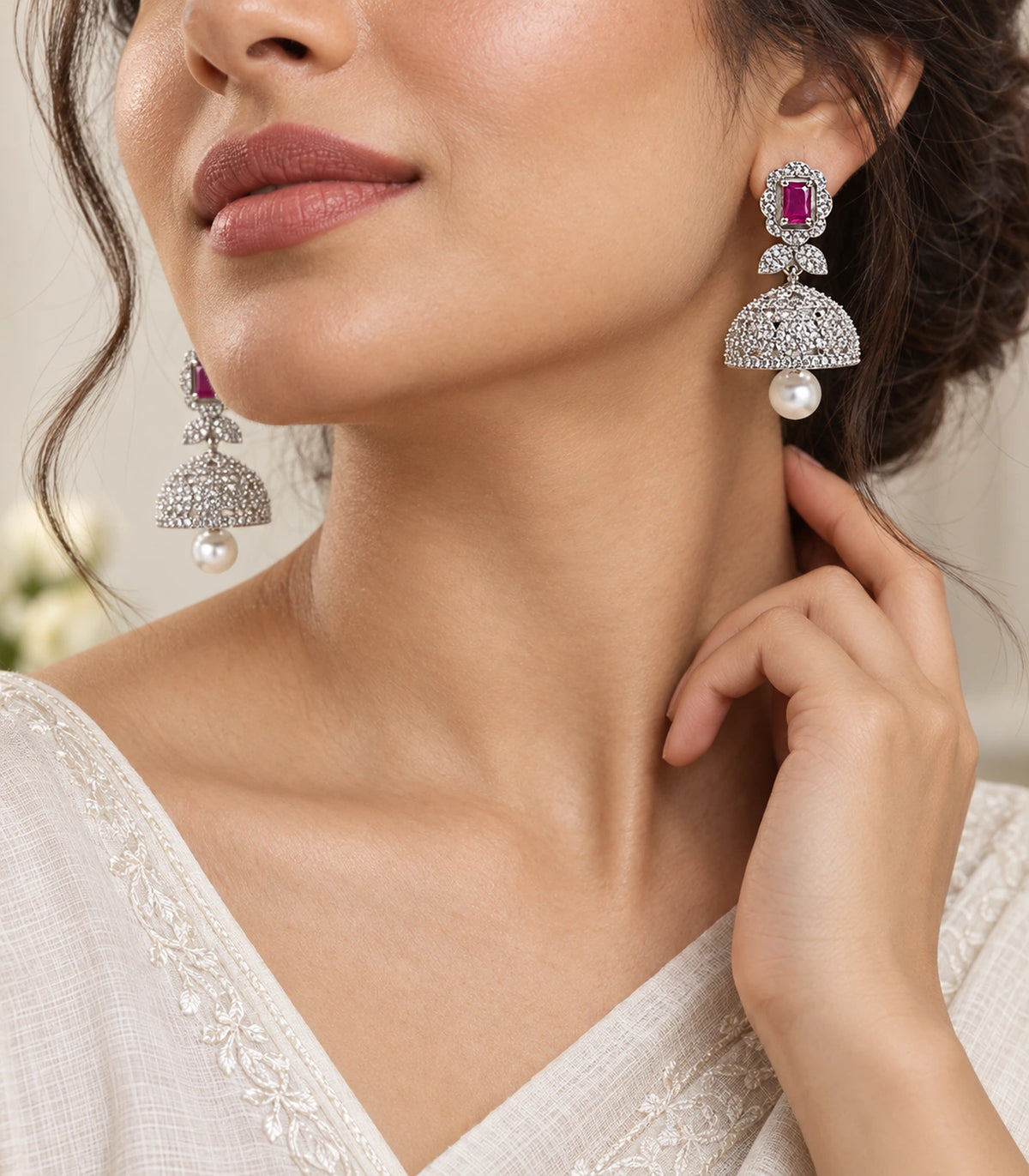 Silver-tone magenta rectangular bow pearl-style jhumka earrings in editorial worn view