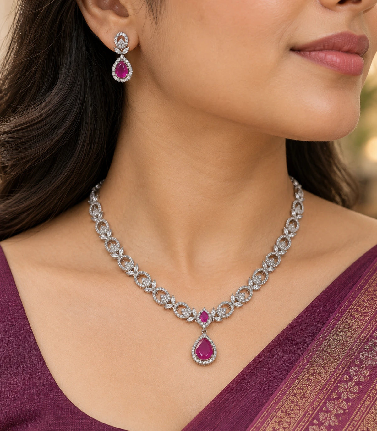 Close view of the magenta pendant, linked necklace and matching earring worn naturally