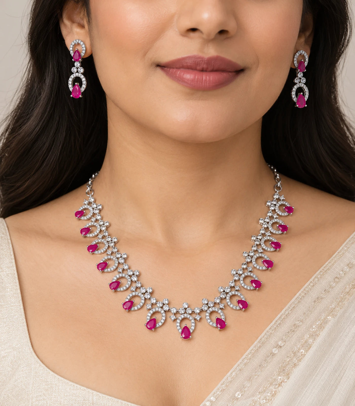 Silver-tone magenta teardrop necklace set and matching earrings worn with an ivory outfit