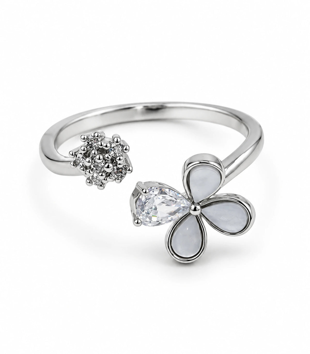 Silver-tone open ring on white background with three pale teardrop petals, one clear teardrop and opposite crystal cluster