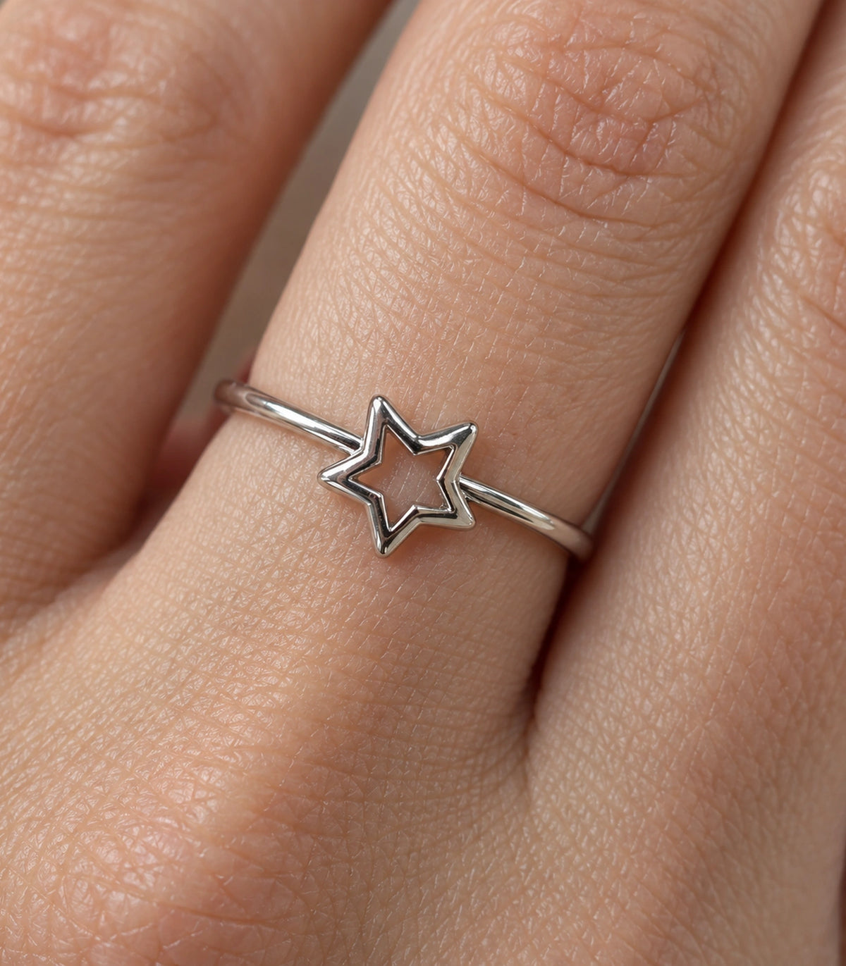 Closeup of Silver Open Star Minimal Ring on a finger