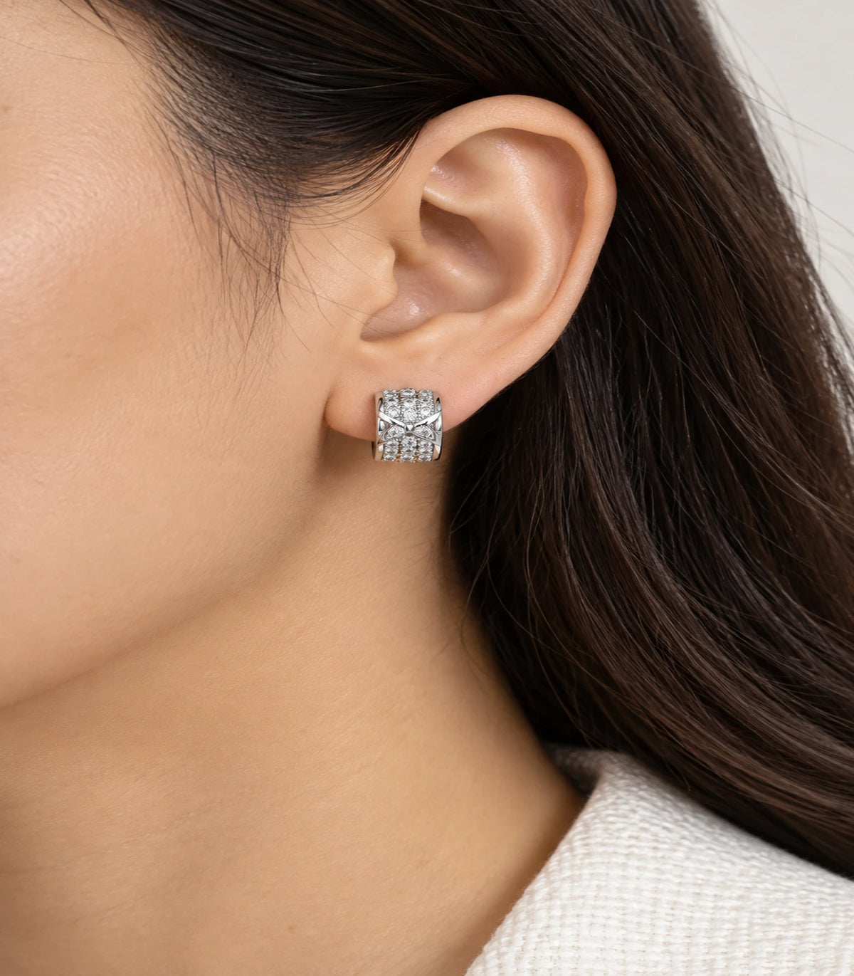 JIMIKI Silver Pave Bow Cross Huggie Earrings — worn styling view #color_silver