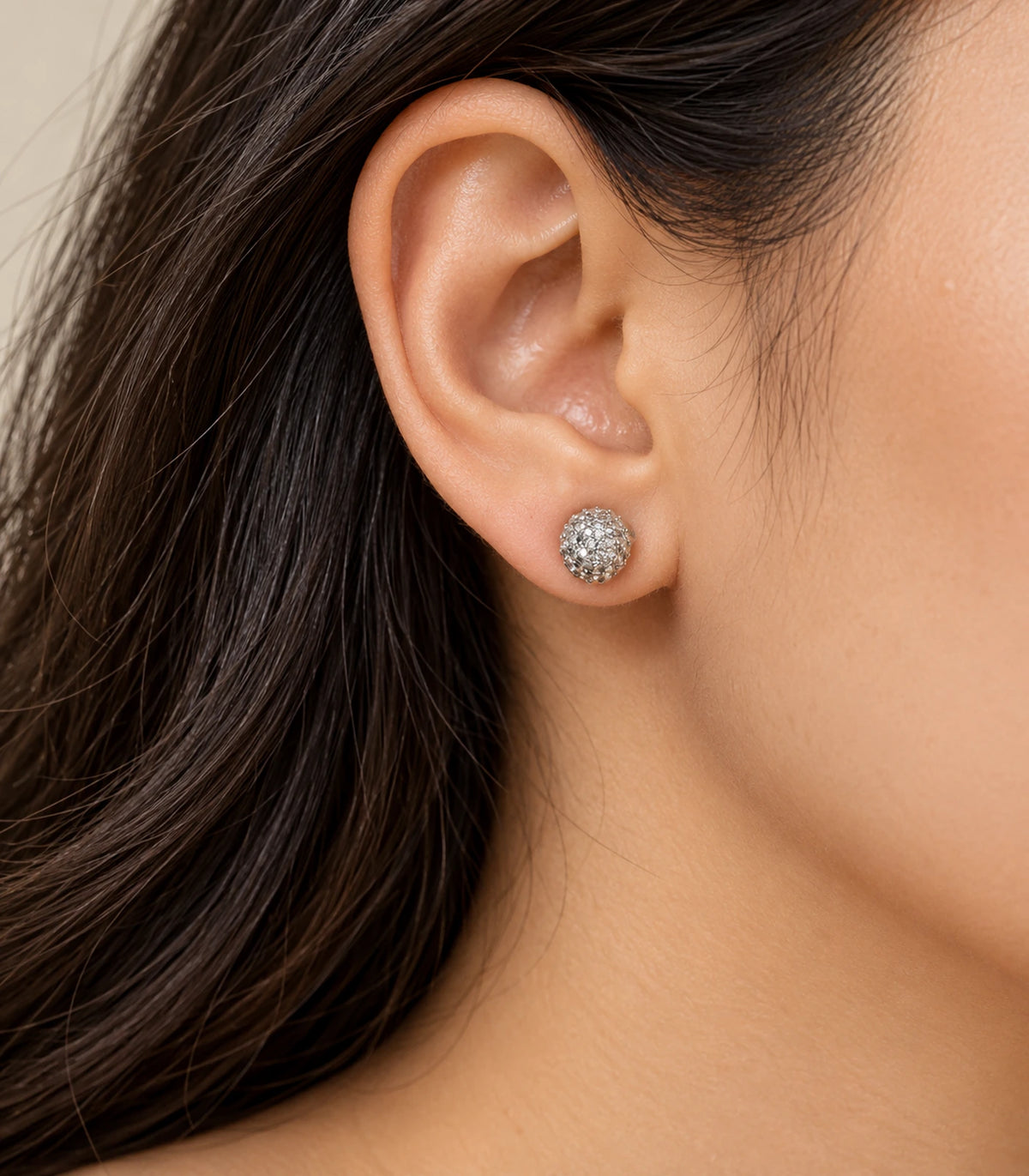 Silver-tone pavé sphere stud earring shown in a second worn composition