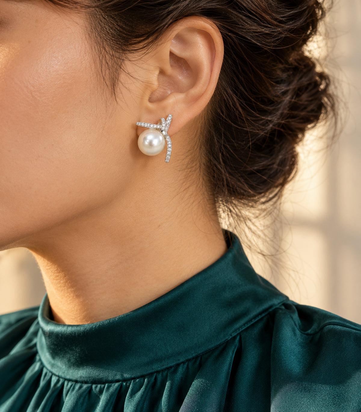 Silver-tone pavé star pearl-look stud earring worn with a teal high-neck blouse