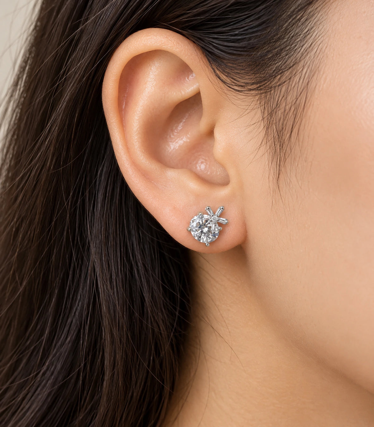 Silver-tone round crystal-style and baguette burst stud earring in an alternate worn view