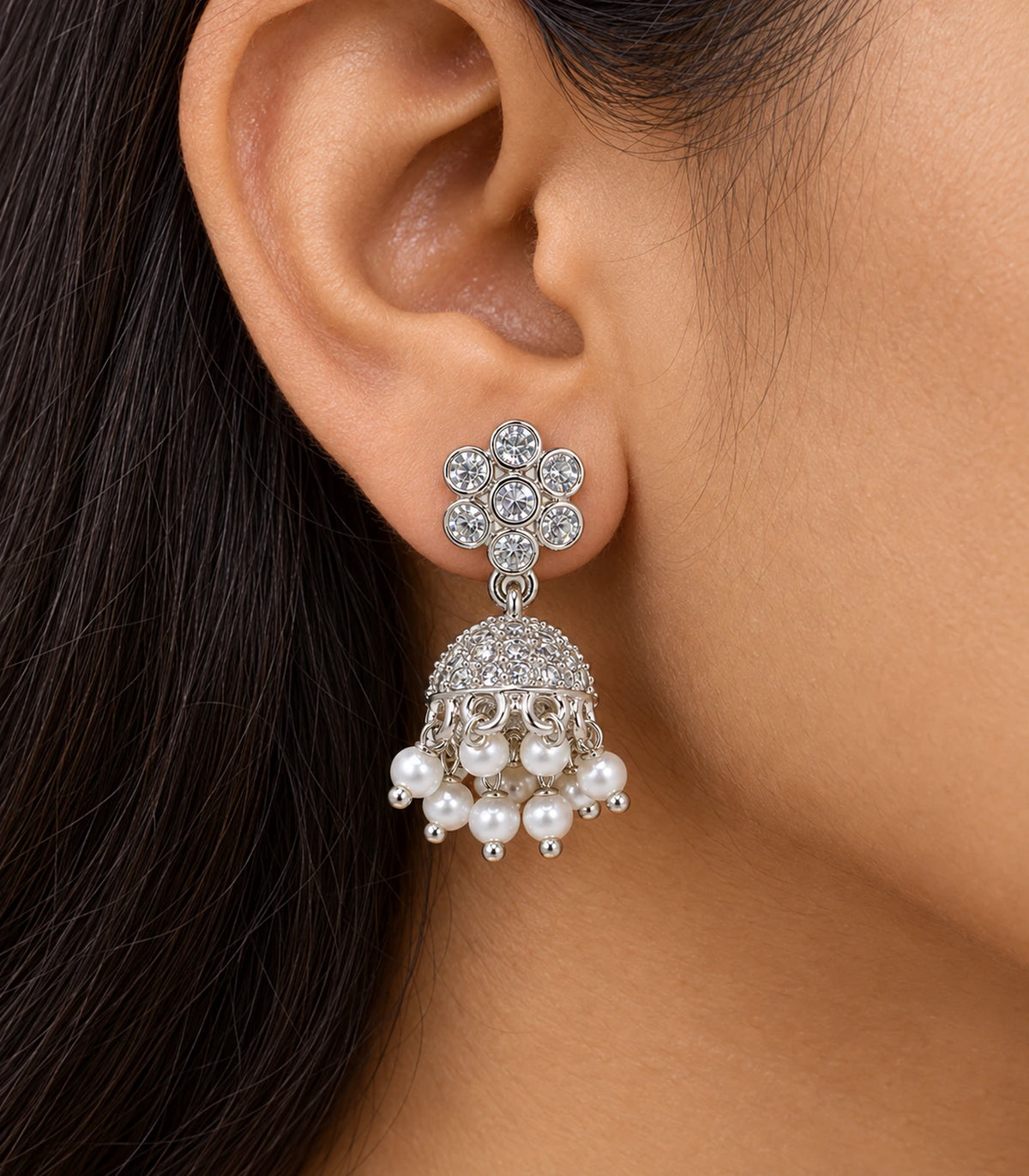 JIMIKI Silver Seven-Stone Flower Jhumka Earrings - Worn close-up of seven-stone flower top and bell drop #color_silver