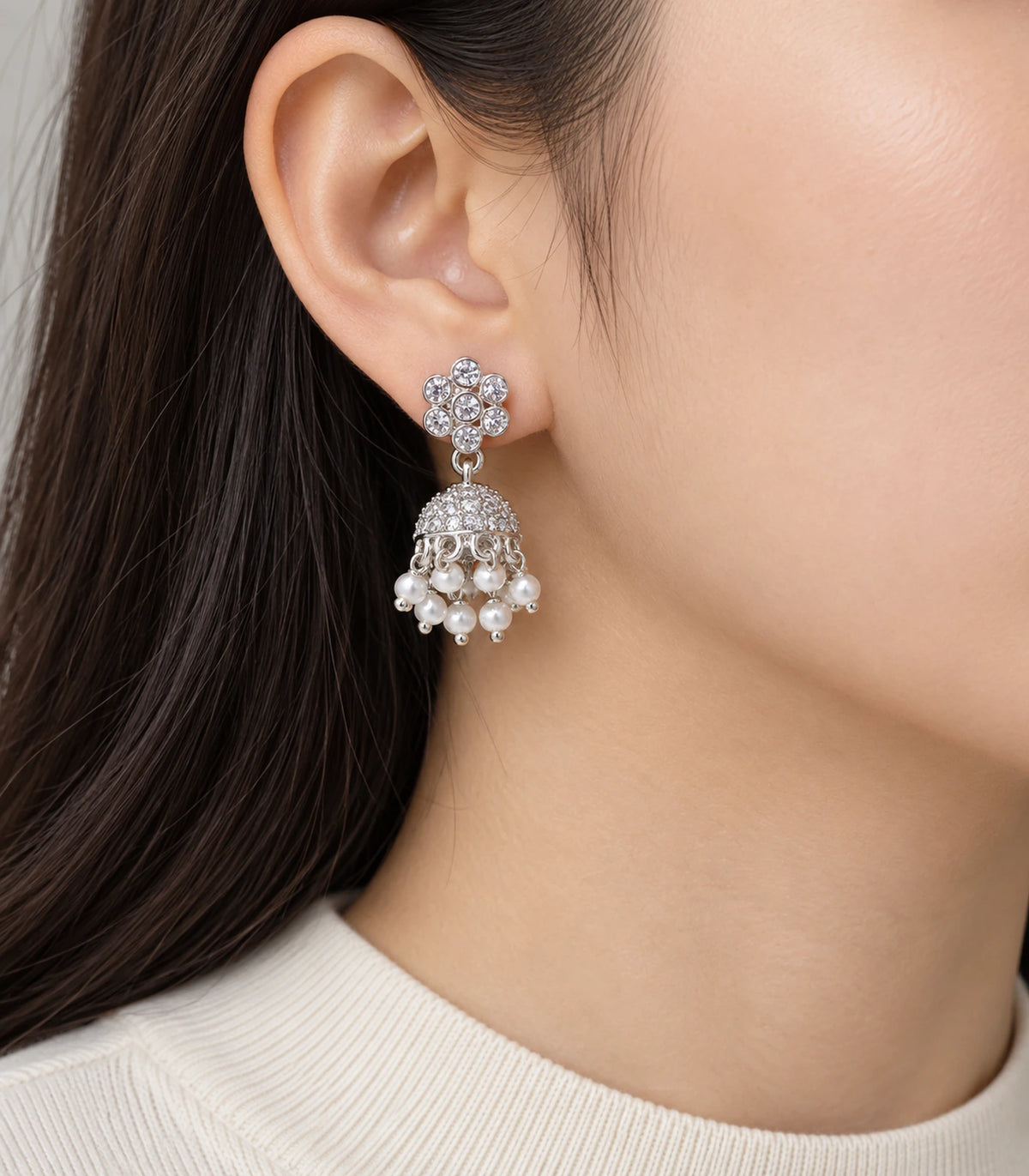 JIMIKI Silver Seven-Stone Flower Jhumka Earrings - Earring worn with a cream outfit #color_silver