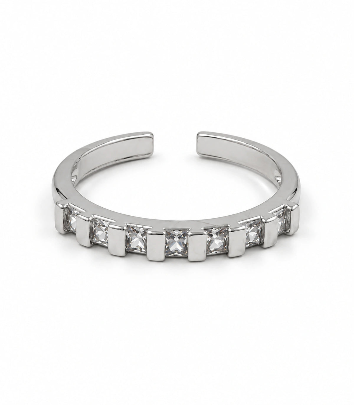 Silver-tone open-back ring with seven square clear crystals and alternating rectangular bars on white