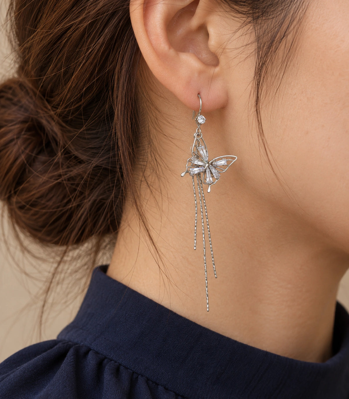 JIMIKI Silver Tone Baguette Butterfly Three Chain Earring Pair in Silver-tone, editorial model view