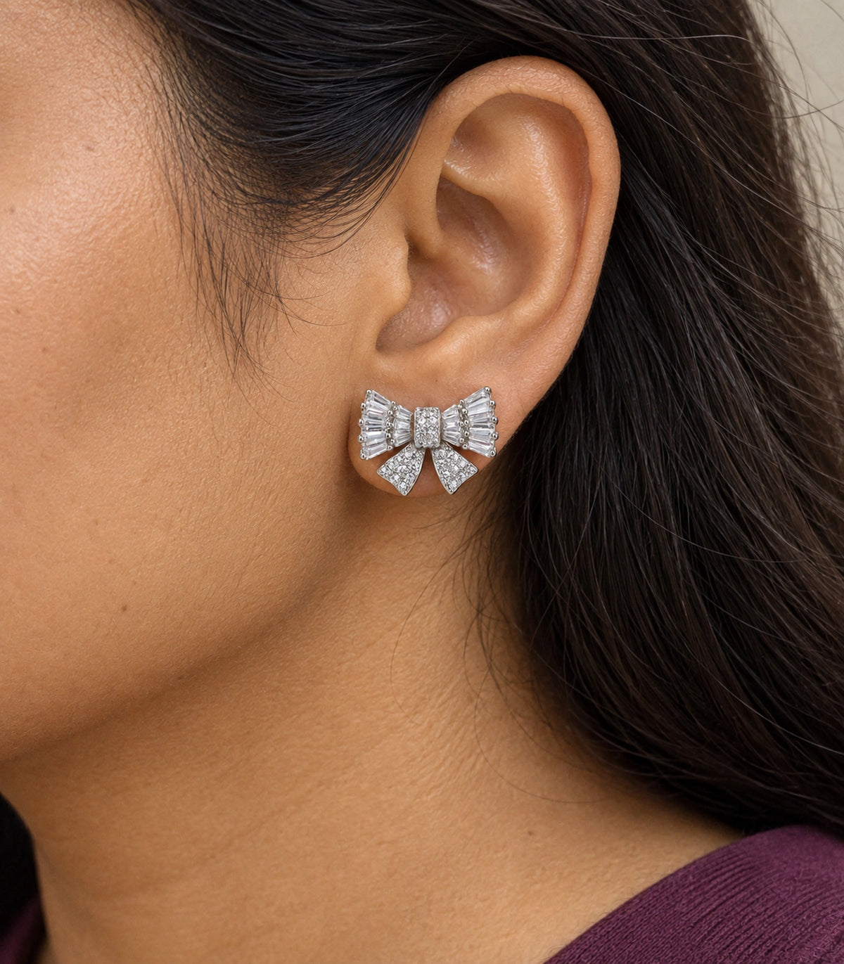 JIMIKI Baguette Crystal Bow Stud Earring Pair in Silver-tone, close-up detail #color_silver-tone