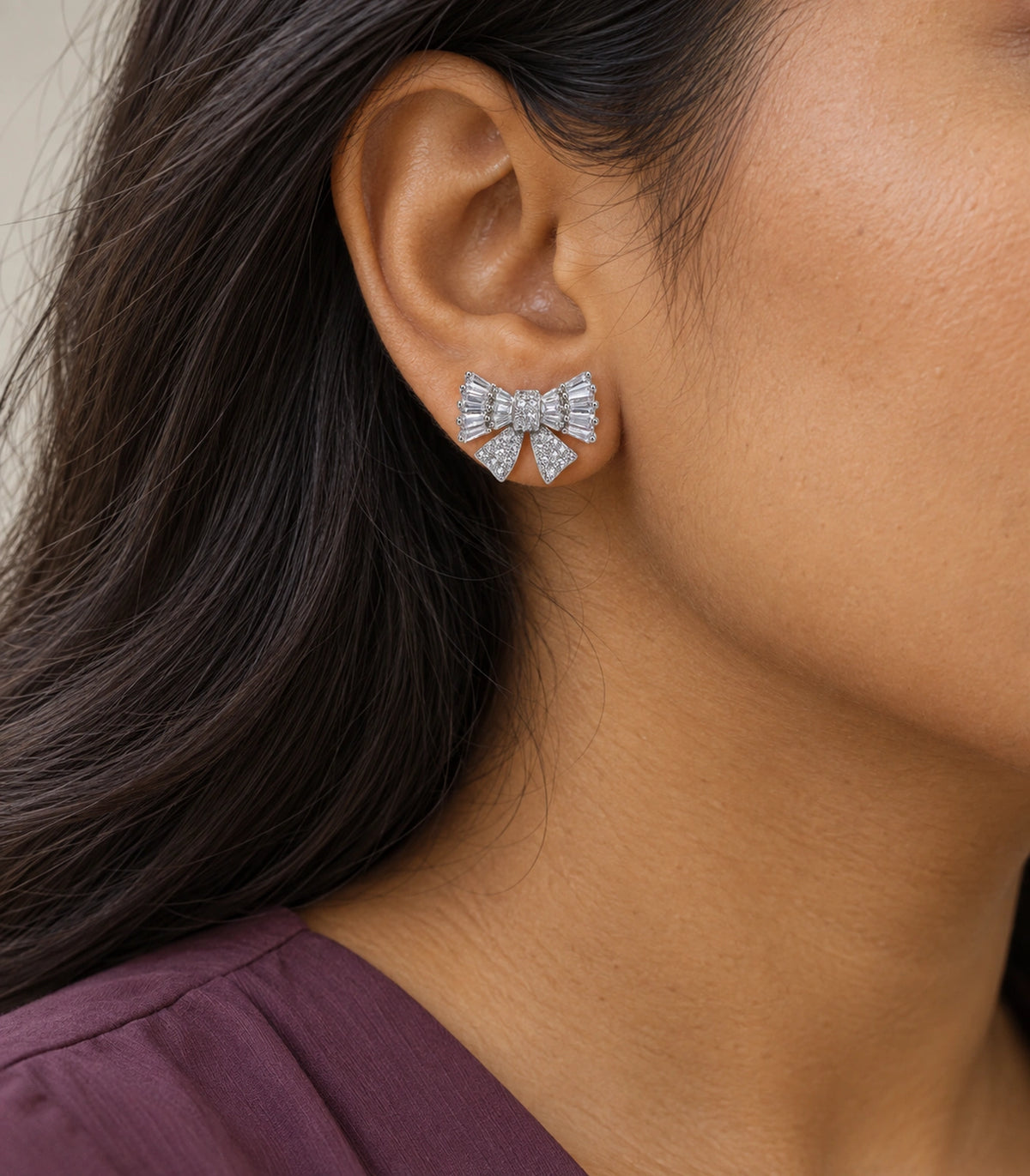 JIMIKI Baguette Crystal Bow Stud Earring Pair in Silver-tone, model wearing view #color_silver-tone