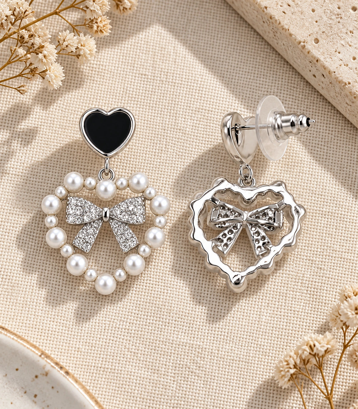 JIMIKI Heart Pearl Bow Drop Earring Pair in Silver Tone / Black, editorial flat lay #color_silver tone / black
