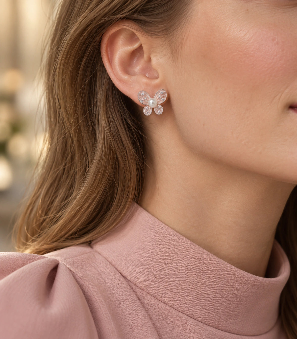 JIMIKI Silver Tone Blush Pink Pearl Butterfly Stud Earring Pair in Blush pink, editorial model view