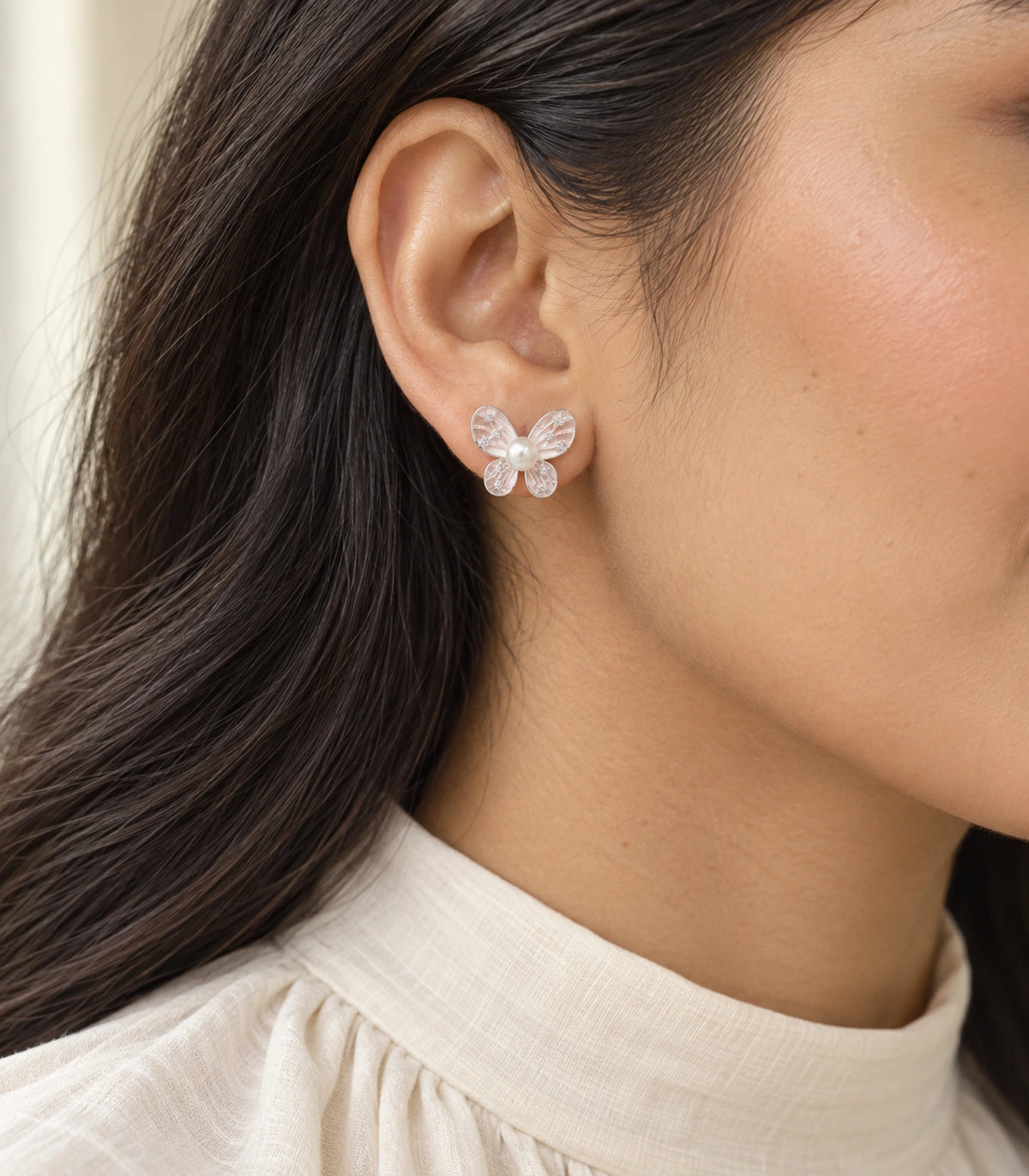 JIMIKI Silver Tone Blush Pink Pearl Butterfly Stud Earring Pair in Blush pink, model wearing view