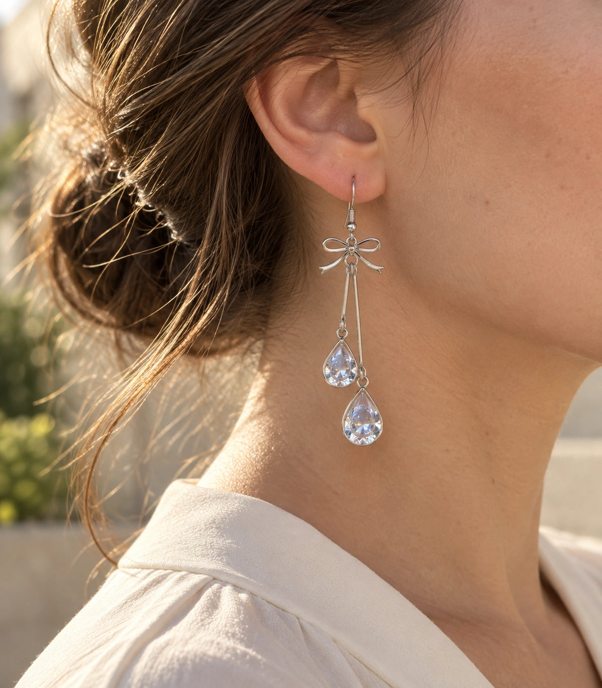 JIMIKI Silver Tone Bow Twin Pear Wire Drop Earring Pair in Silver-tone, editorial model view