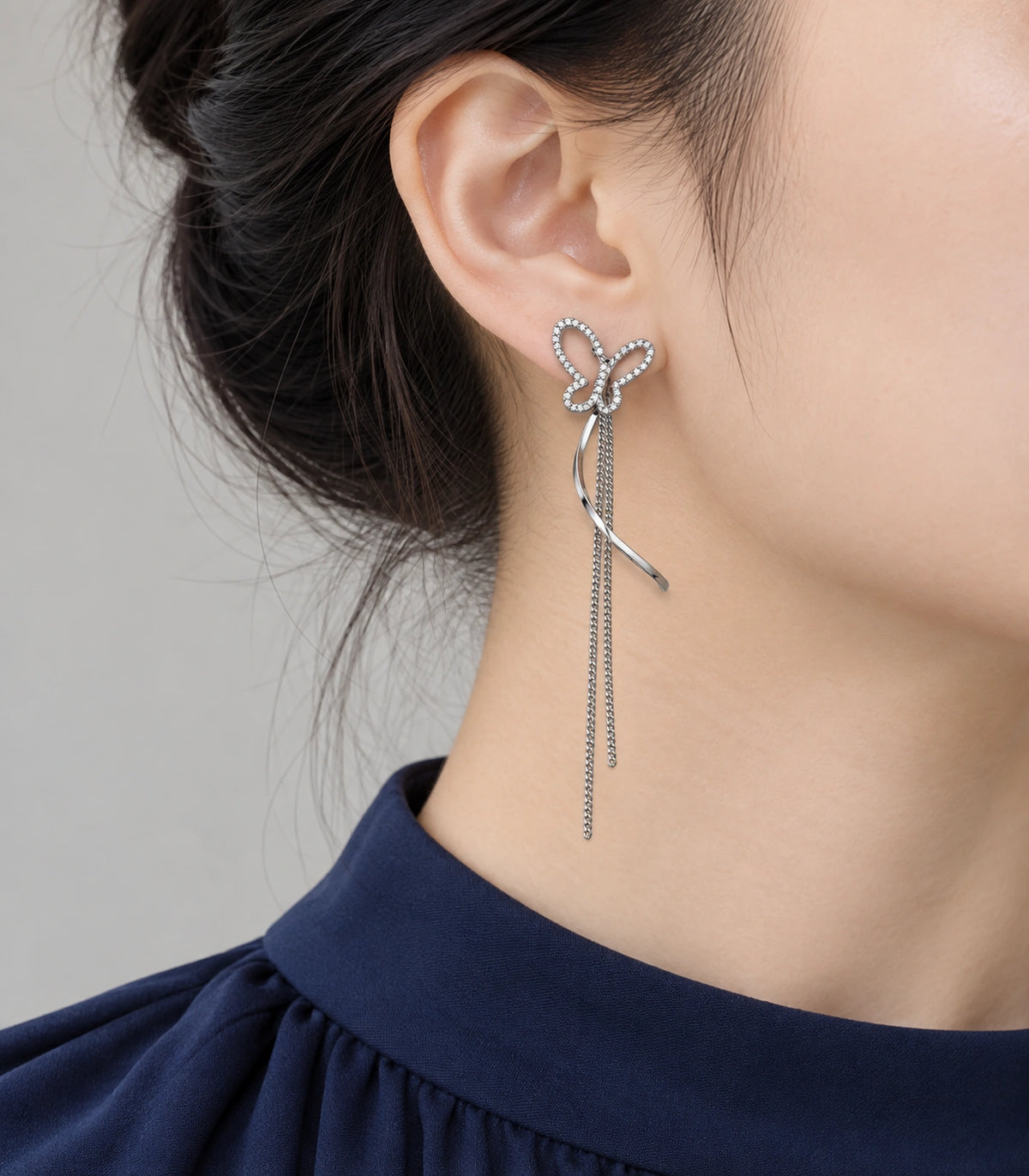JIMIKI Butterfly Ribbon Chain Drop Earrings in Silver-tone, model wearing view #color_silver-tone