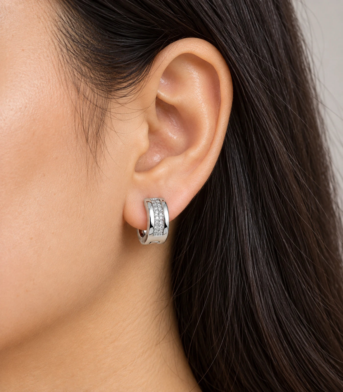 JIMIKI Silver central pave strip huggie hoop earrings, worn on the ear #color_silver