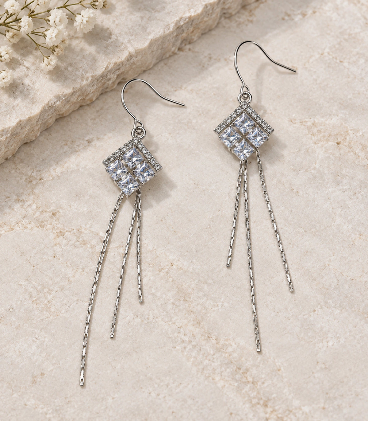 JIMIKI Silver Tone Chevron Crystal Three Chain Earring Pair in Silver-tone, editorial flat lay
