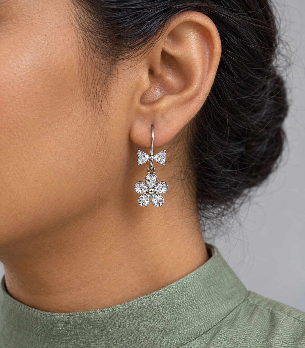 JIMIKI Silver Tone Clear Bow Five Petal Flower Drop Earring Pair in Silver tone / clear, model wearing view