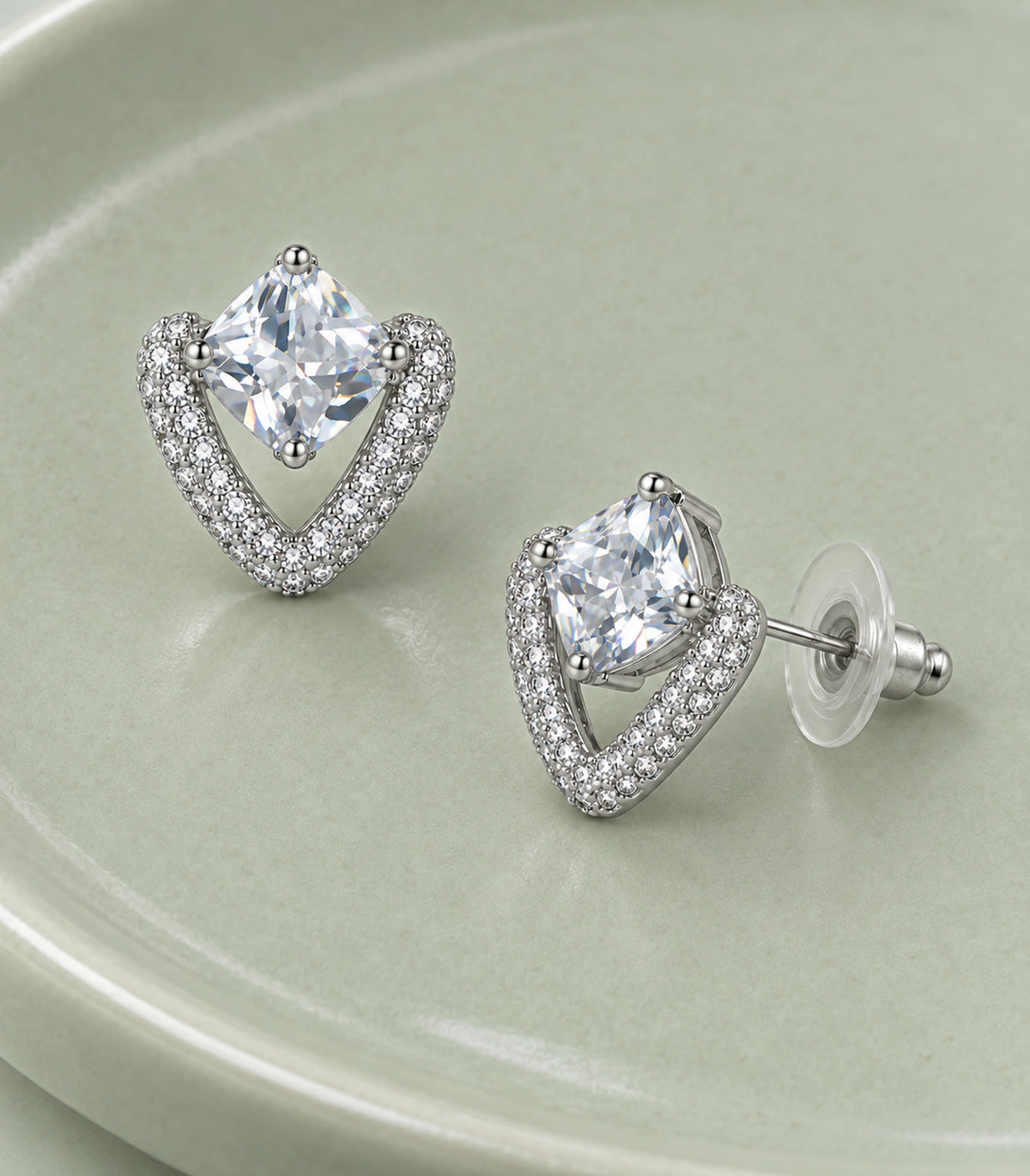 JIMIKI Silver Tone Clear Cushion Crystal Open Heart Stud Earring Pair in Silver-tone, editorial flat lay