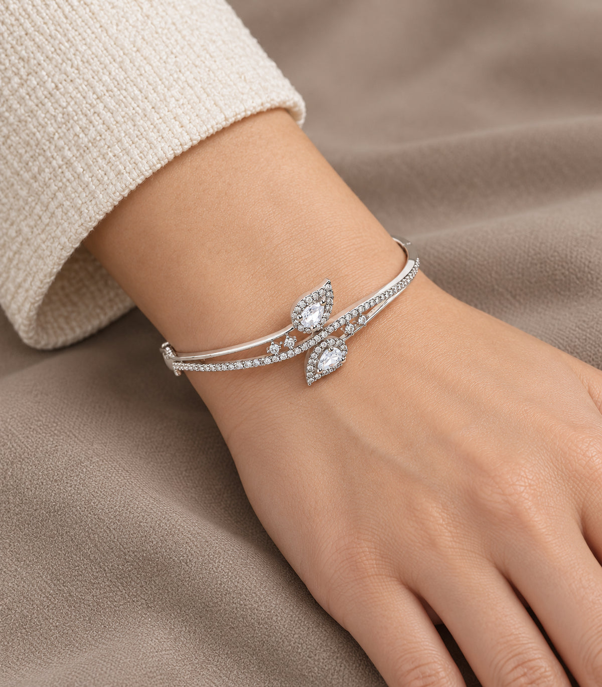 Close detail of silver-tone clear double leaf bangle