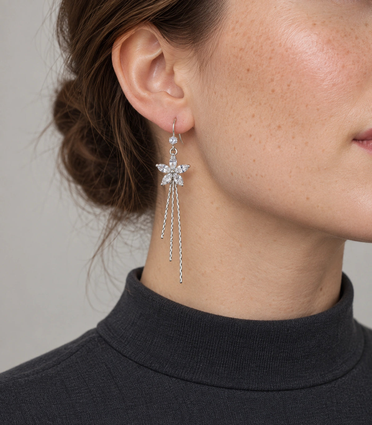JIMIKI Silver Tone Clear Five Petal Flower Chain Tassel Earring Pair in Silver tone / clear, model wearing view