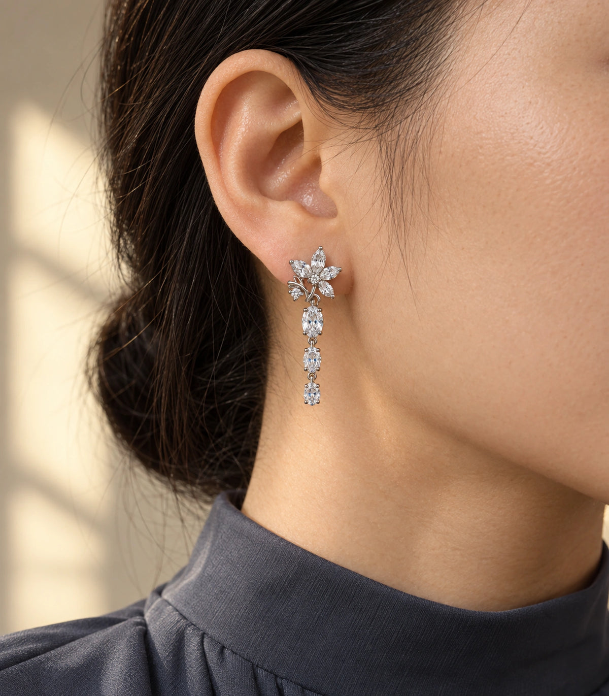 JIMIKI Floral Triple Oval Drop Earring Pair in Silver tone / clear, editorial model view #color_silver tone / clear