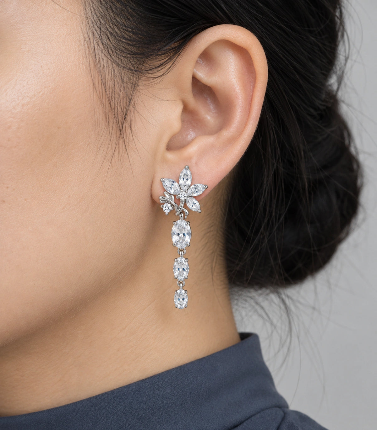 JIMIKI Floral Triple Oval Drop Earring Pair in Silver tone / clear, model wearing view #color_silver tone / clear