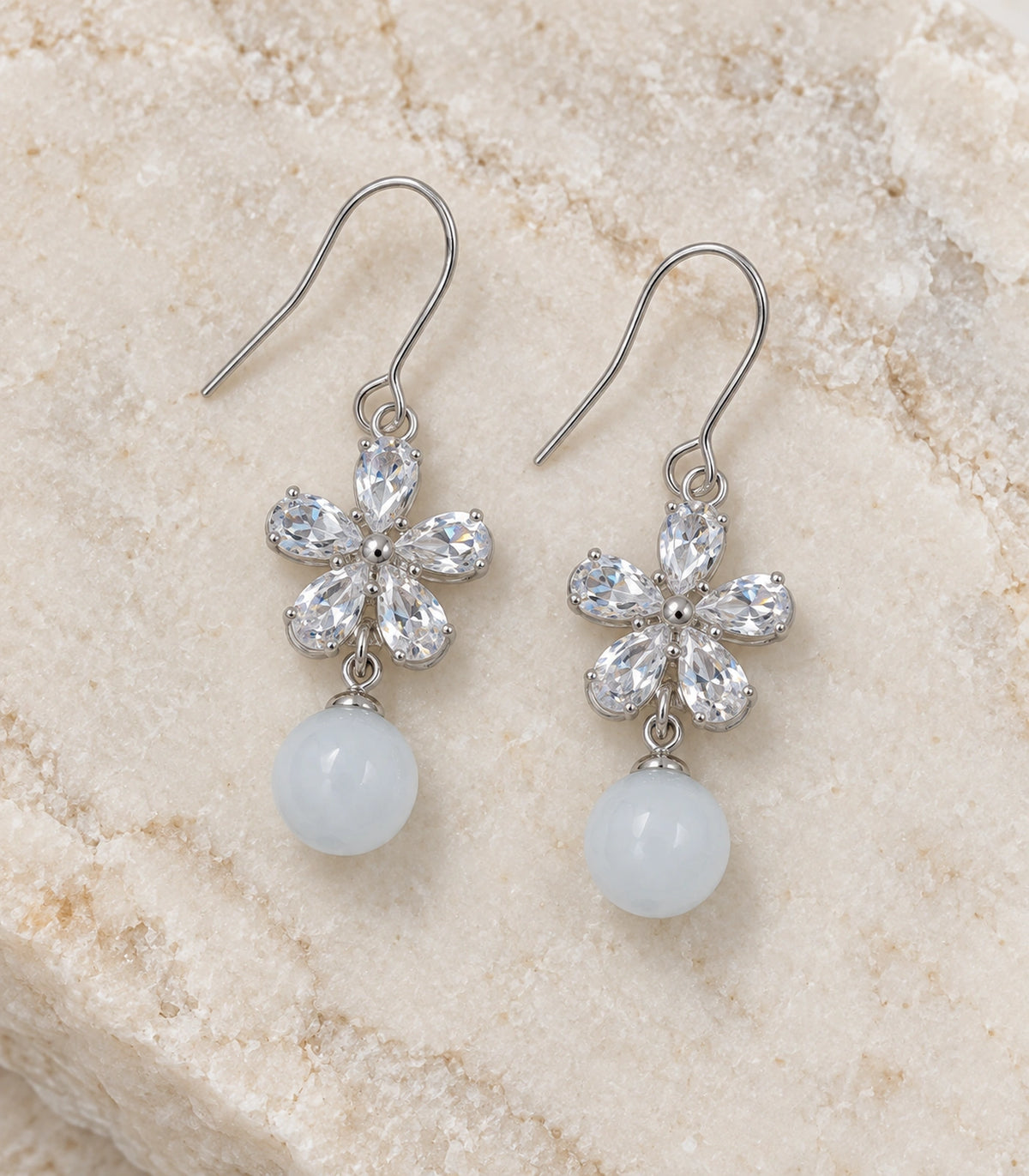 JIMIKI Silver Tone Clear Flower White Bead Drop Earring Pair in Silver-tone, editorial flat lay